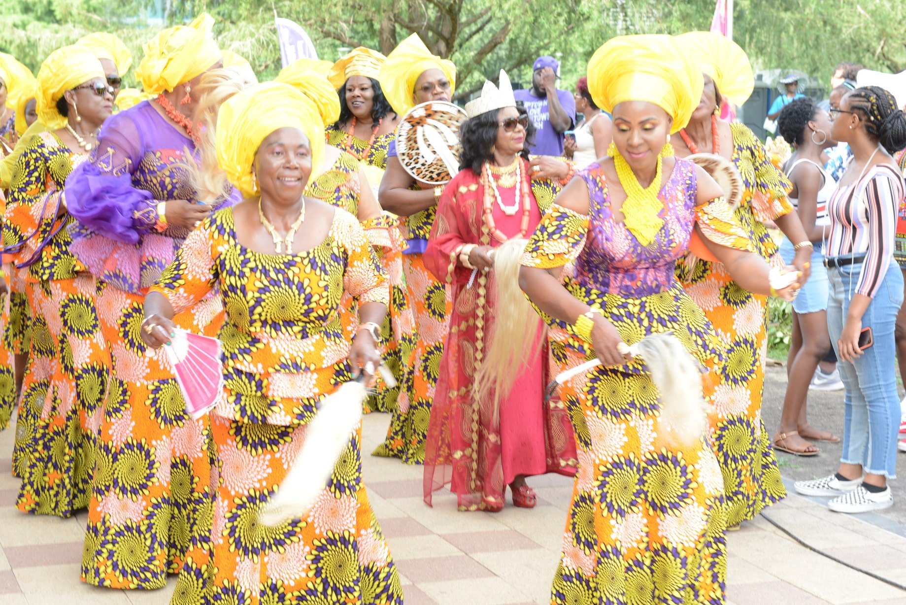 Women wearing traditional Nigerian outfits dance at Igbo Fest at Discovery Green