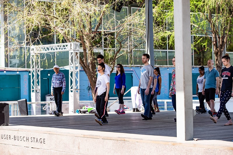 A woman leads a Tai Chi class at Discovery Green in Downtown Houston