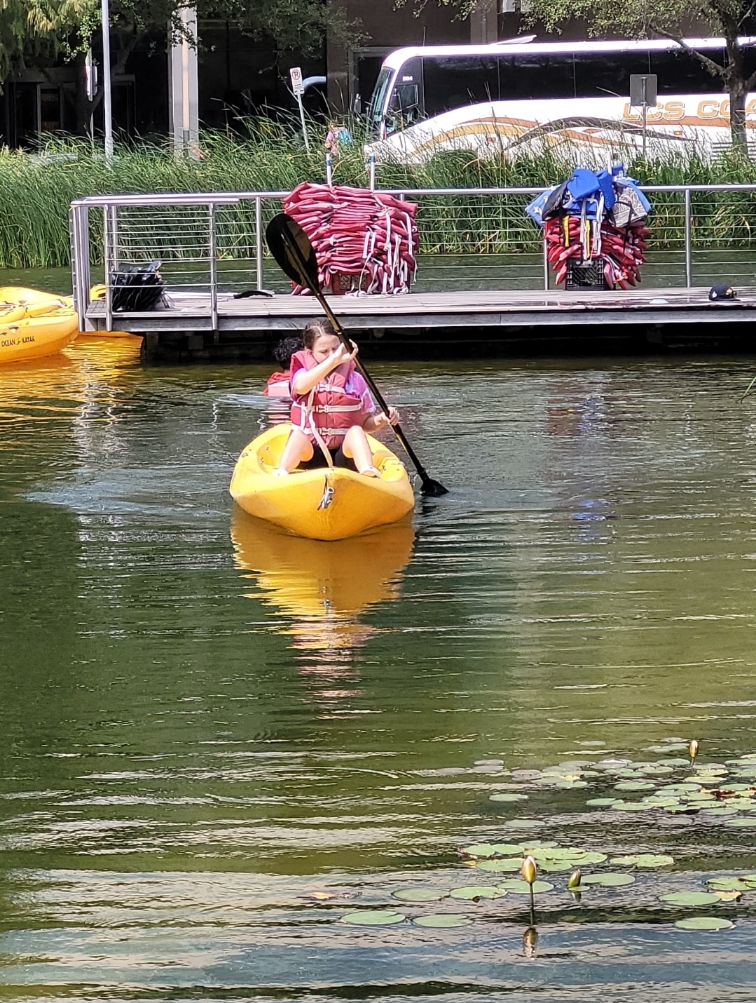 A little girl kayaks at Kinder Lake in Downtown Houston
