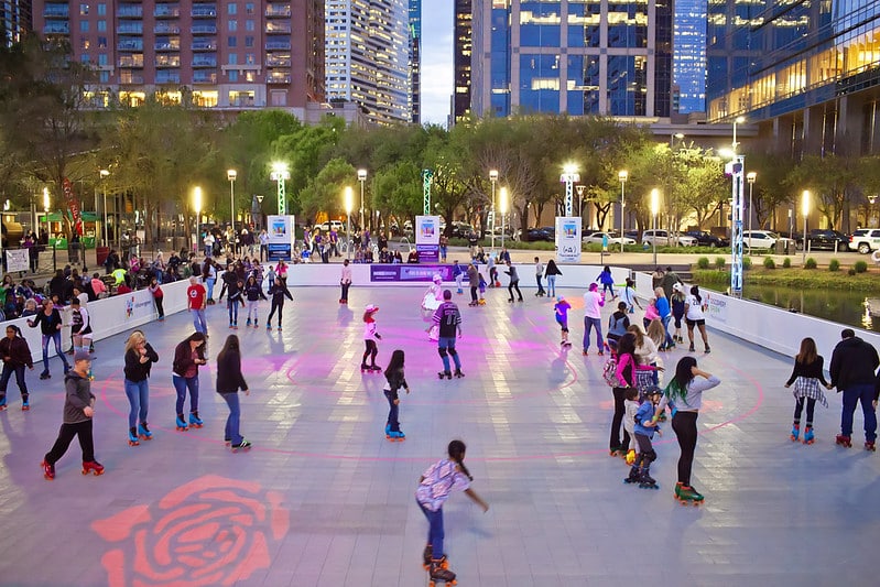 People skating around the roller rink in Downtown Houston at Discovery Green