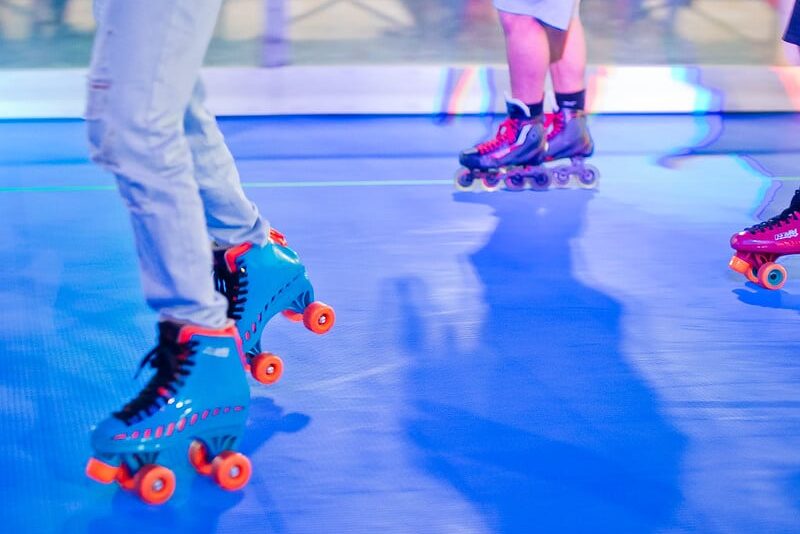 People enjoying the roller rink with different types of skates in Downtown Houston