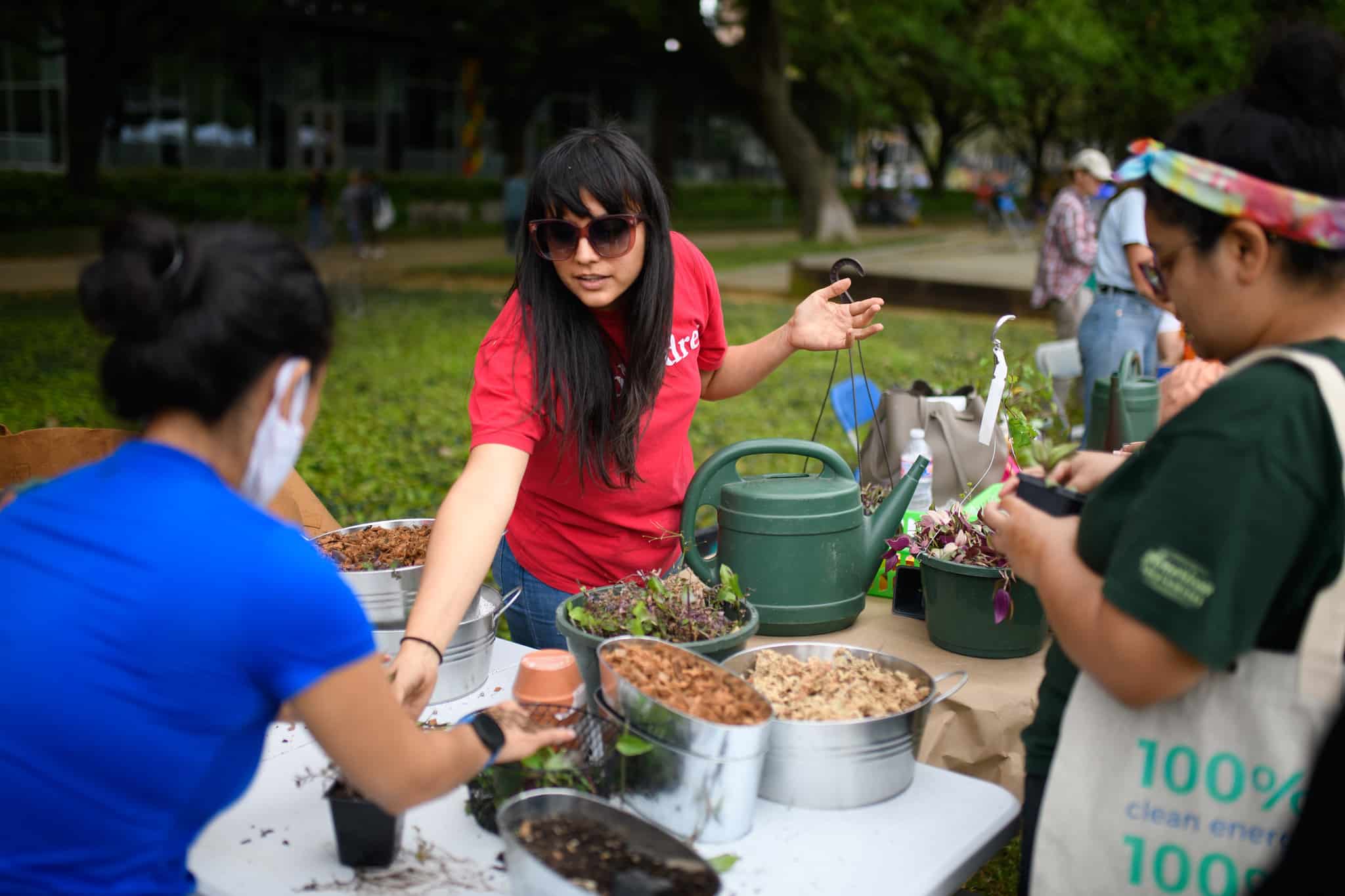 A vendor shows the plants she has for sale at Green Mountain Energy Earth Day at Discovery Green