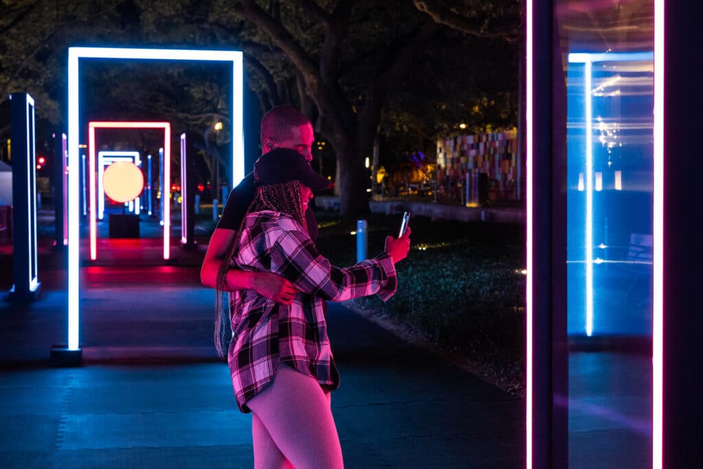 A couple takes a selfie at Solstice by Studio Iregular at Discovery Green