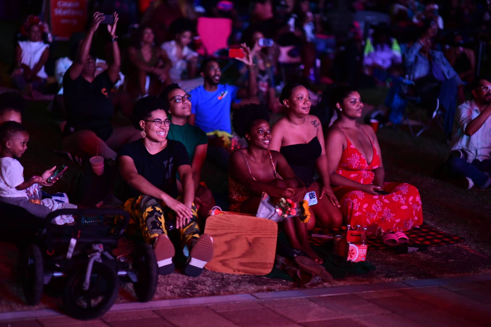 People enjoy free concerts at Discovery Green during UHD Thursday Night Concerts. Photo by Jamaal Ellis.
