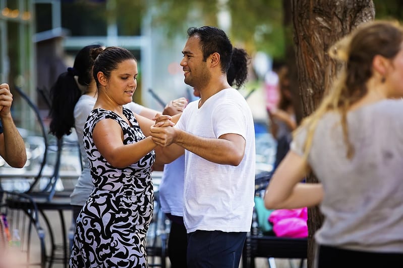 Man and woman dancing salsa at Discovery Green in Downtown Houston