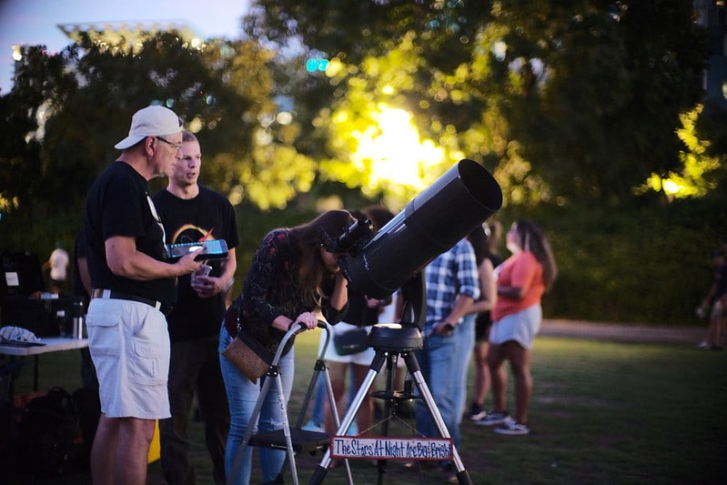 People stargazing through a telescope at Discovery Green in Downtown Houston