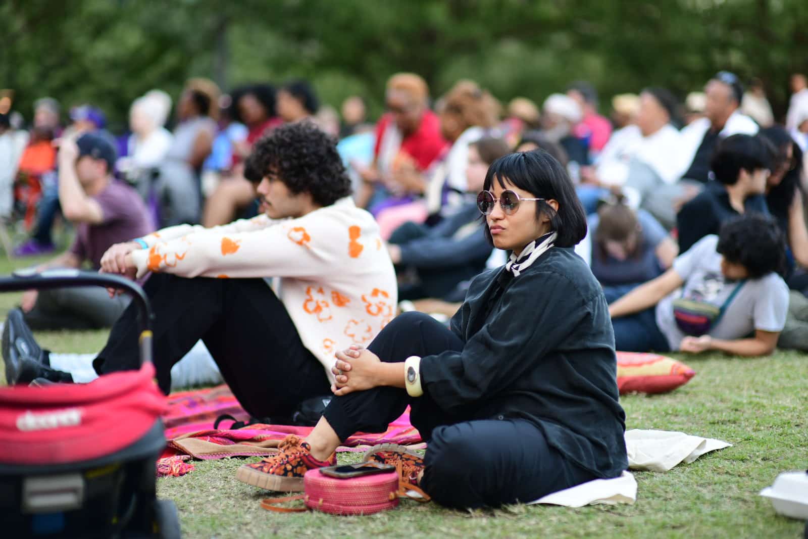 A woman enjoys a daytime concert at Discovery Green