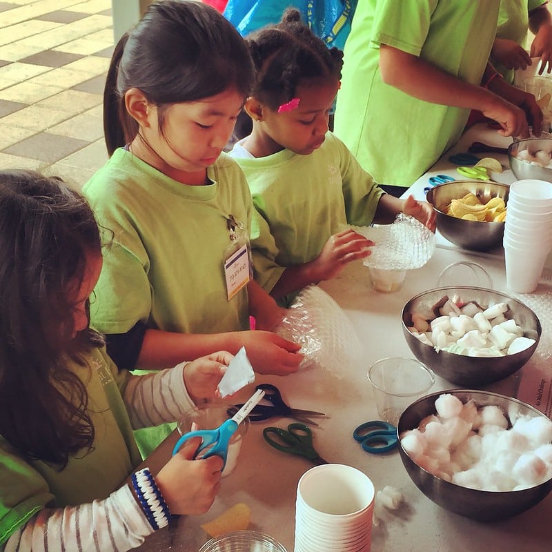 Girls doing hands on activity during spring break at Discovery Green.